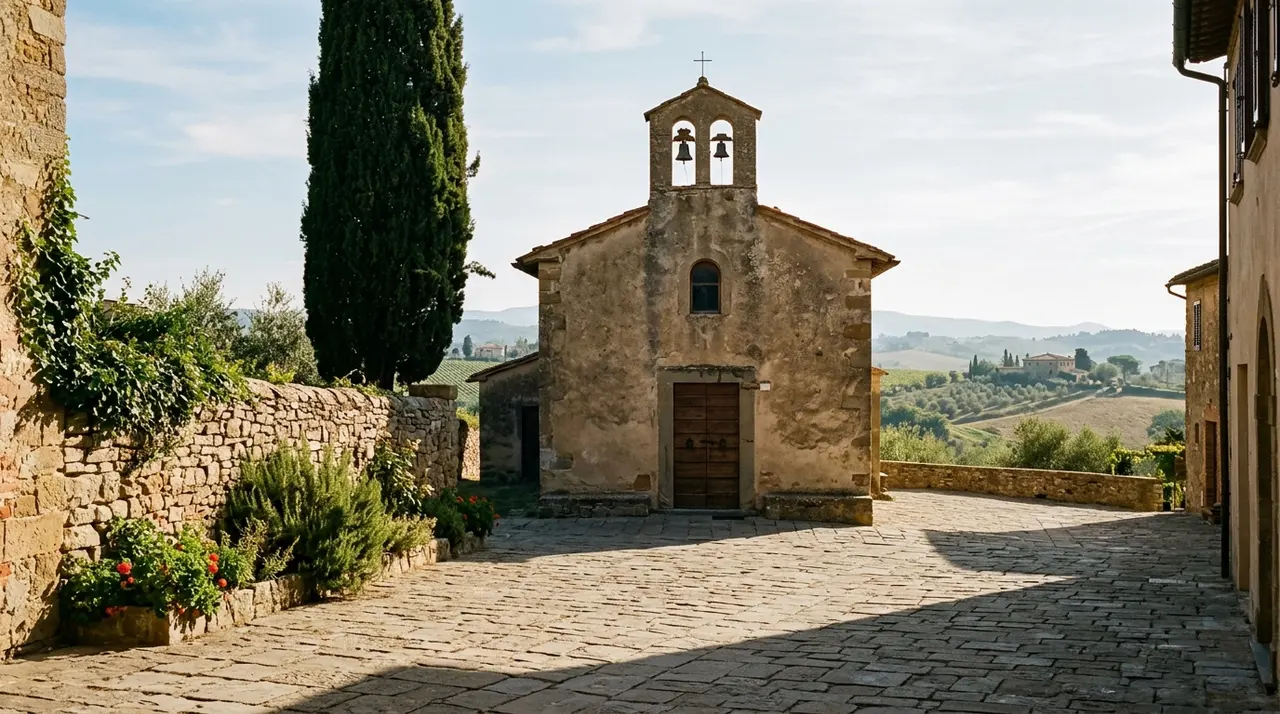 Chiesa di paese con il portone chiuso e la piazza selciata deserta in Toscana nella luce del mattino, prima di un funerale